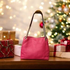 Michael Kors fushia pebbled leather shoulder bag.